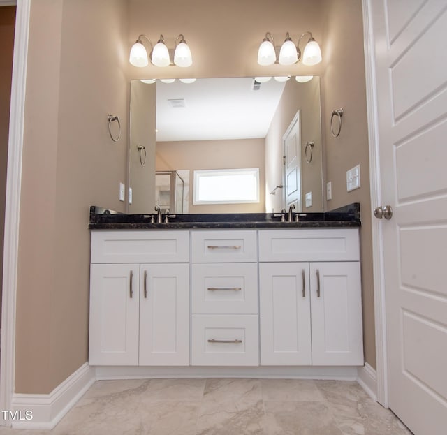 bathroom with vanity and a shower with shower door