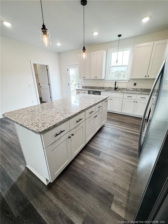 kitchen with white cabinets, dark hardwood / wood-style floors, plenty of natural light, and decorative light fixtures