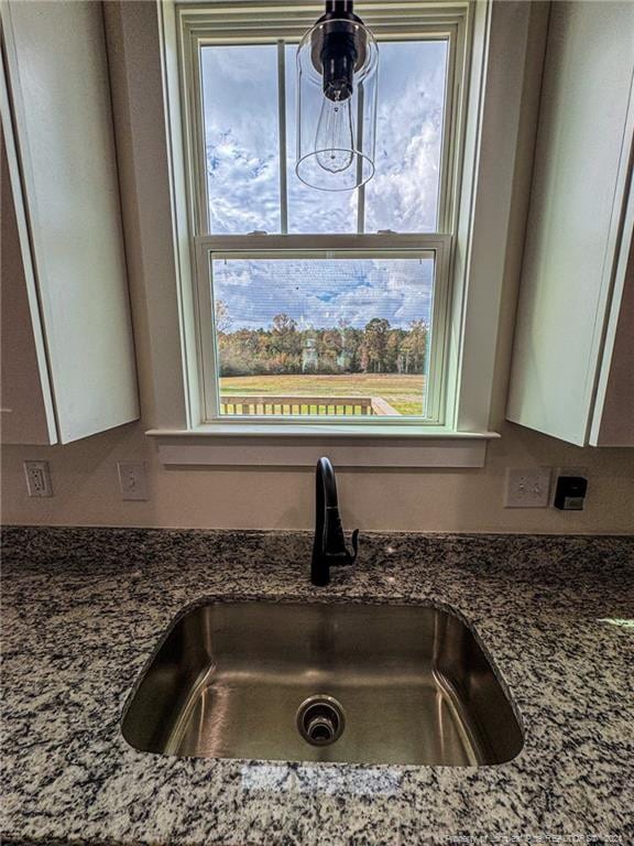 details with sink and dark stone countertops