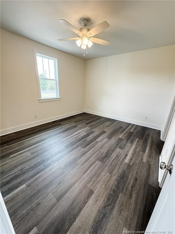 spare room with ceiling fan and dark hardwood / wood-style floors