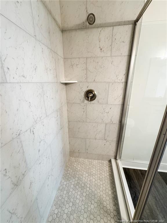 bathroom with a tile shower