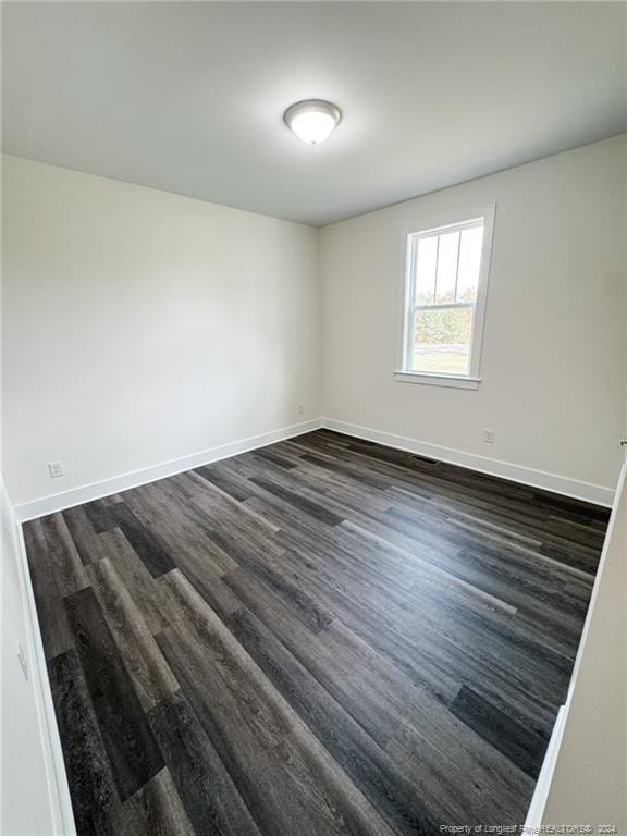 empty room featuring dark hardwood / wood-style floors