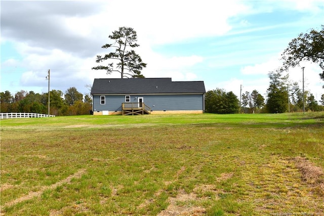 rear view of property featuring a yard