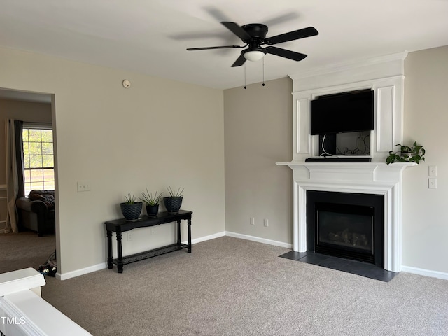 carpeted living room featuring ceiling fan and a large fireplace