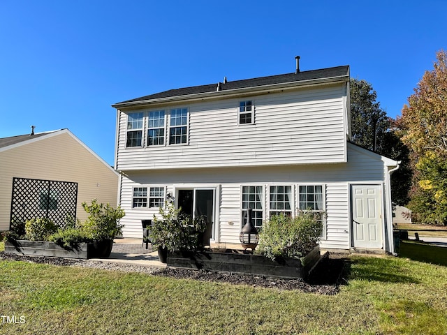 rear view of property featuring a yard