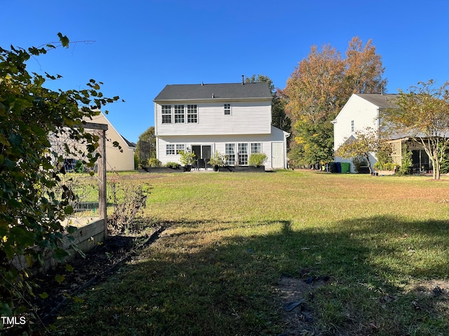 back of property featuring a yard