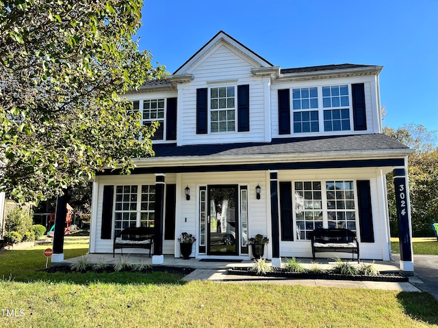 front facade with a front yard and a porch