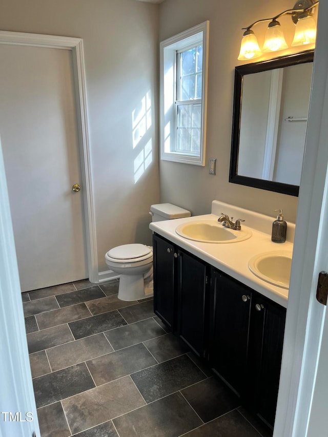 bathroom with toilet and vanity