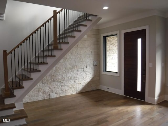 entryway with hardwood / wood-style flooring and ornamental molding