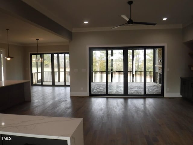 interior space with ornamental molding, ceiling fan, and dark wood-type flooring