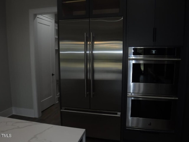 kitchen featuring light stone countertops and appliances with stainless steel finishes