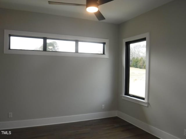 spare room featuring ceiling fan and dark hardwood / wood-style floors