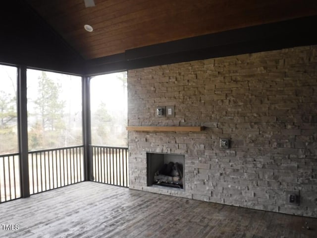 interior space with wooden ceiling, a fireplace, and vaulted ceiling