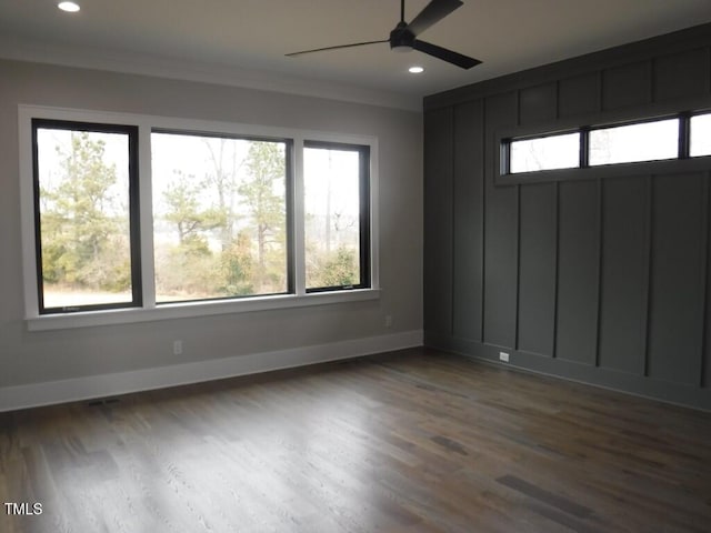 unfurnished room with ceiling fan, dark hardwood / wood-style flooring, and crown molding