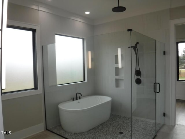 bathroom featuring tile patterned floors and separate shower and tub