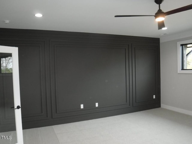 carpeted empty room with plenty of natural light and ceiling fan