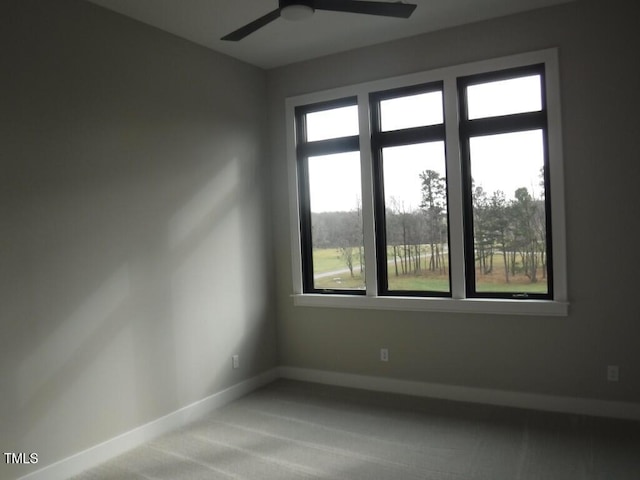 carpeted spare room featuring ceiling fan