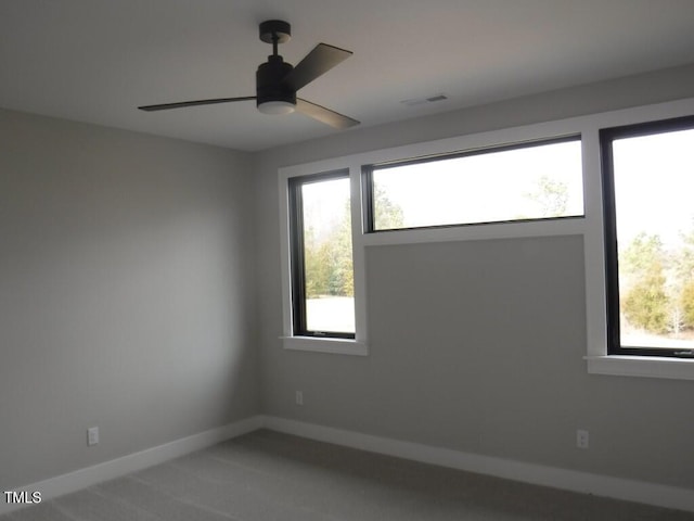 spare room featuring carpet and ceiling fan