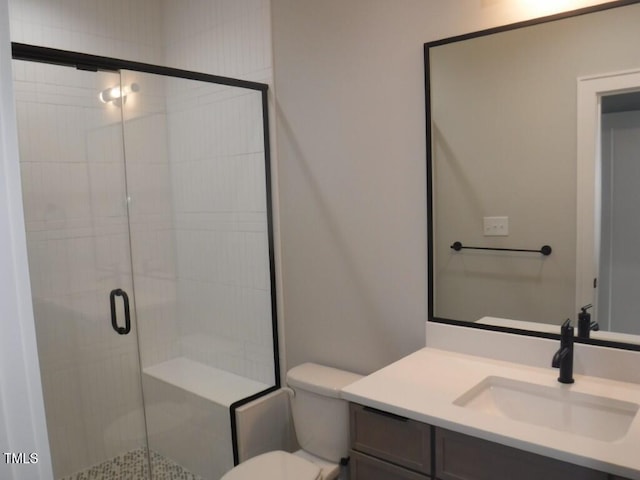 bathroom with vanity, toilet, and walk in shower