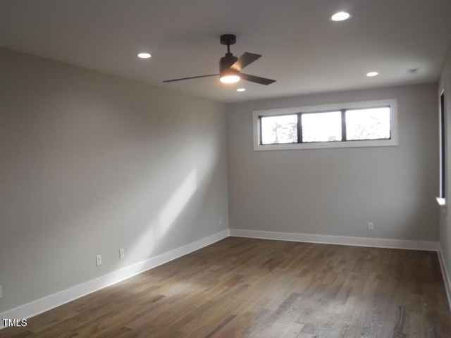 spare room with hardwood / wood-style flooring and ceiling fan