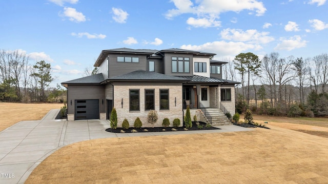 prairie-style house with a garage, a front lawn, and a porch