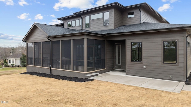 rear view of property with a patio and a sunroom