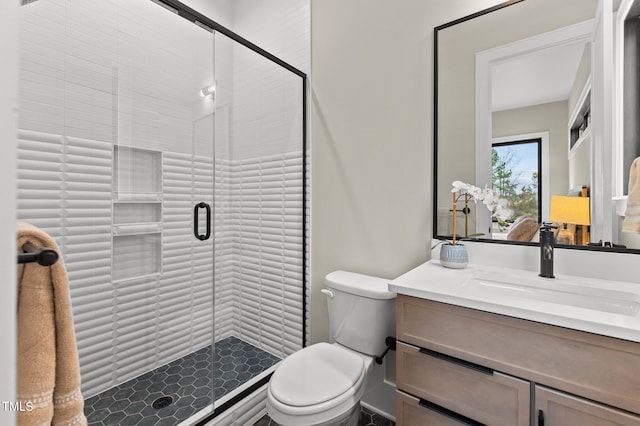 bathroom featuring an enclosed shower, vanity, and toilet