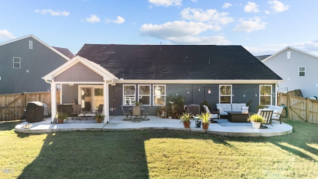 rear view of house with an outdoor living space, a yard, and a patio area