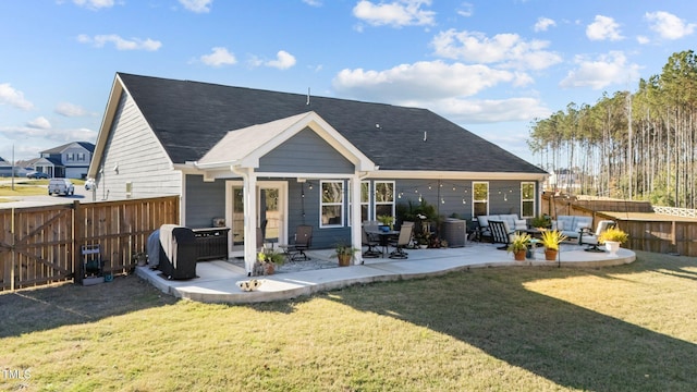 back of house with a yard and a patio area