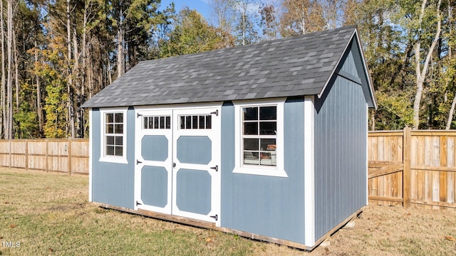 view of outbuilding featuring a lawn