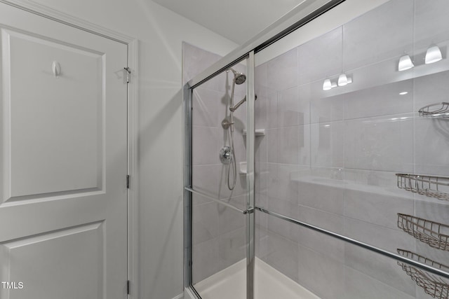 bathroom featuring a shower with door