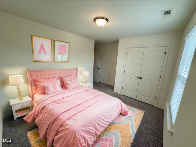 carpeted bedroom with a closet