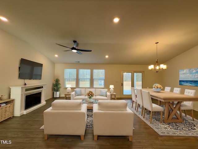 living room with lofted ceiling, dark hardwood / wood-style flooring, and ceiling fan with notable chandelier