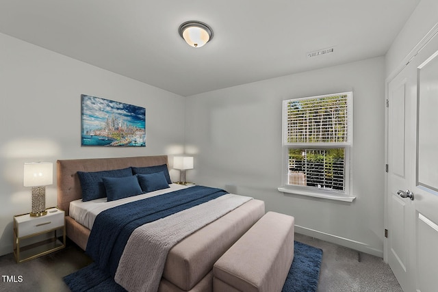 bedroom with dark colored carpet