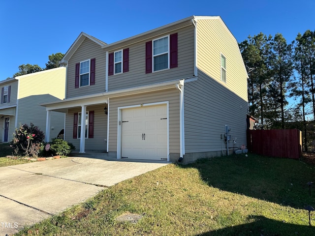 front of property featuring a front lawn, a garage, and covered porch