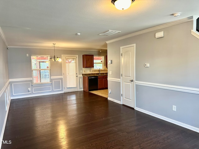 unfurnished living room with dark hardwood / wood-style floors, a chandelier, and ornamental molding