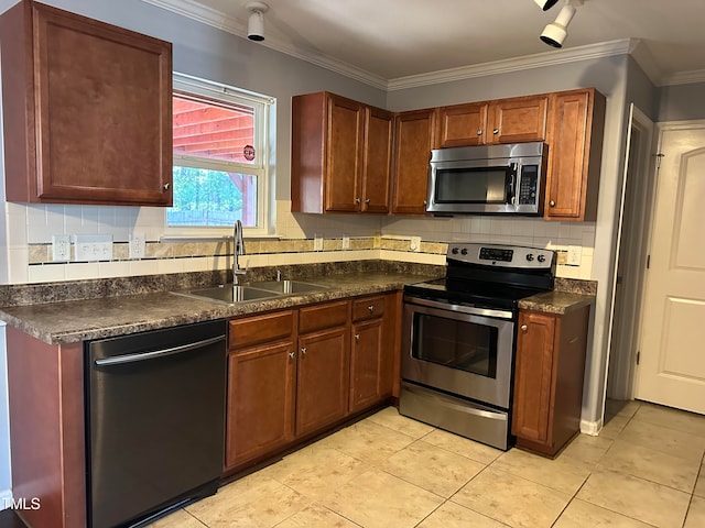 kitchen featuring stainless steel appliances, sink, tasteful backsplash, light tile patterned flooring, and crown molding