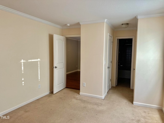 unfurnished bedroom with ornamental molding and light colored carpet