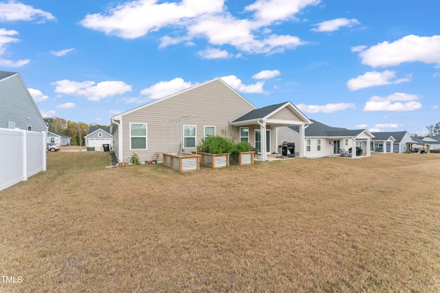 rear view of property with a lawn