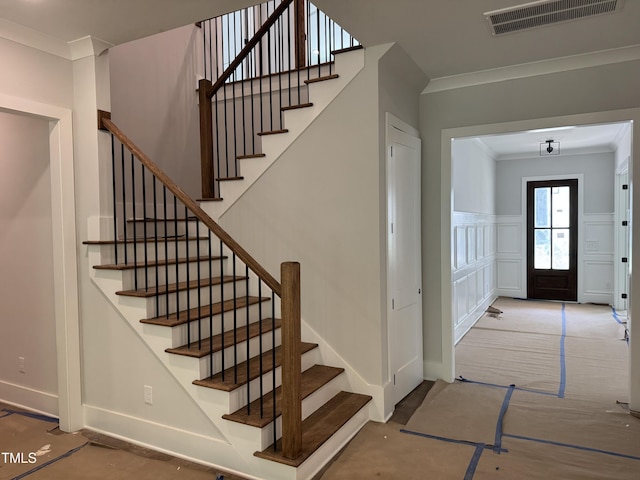 122 Sanderway Dr, Chapel Hill, NC 27516 - entrance foyer featuring ornamental molding, stairway, a wainscoted wall, and a decorative wall