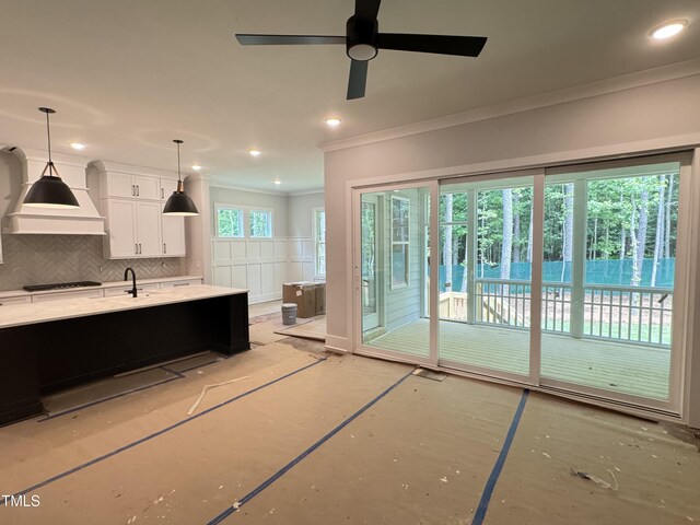 122 Sanderway Dr, Chapel Hill, NC 27516 - kitchen with ornamental molding, gas cooktop, white cabinets, decorative backsplash, and premium range hood