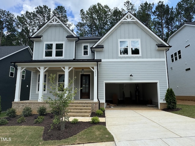 122 Sanderway Dr, Chapel Hill, NC 27516 - craftsman house featuring board and batten siding, a porch, a garage, and driveway