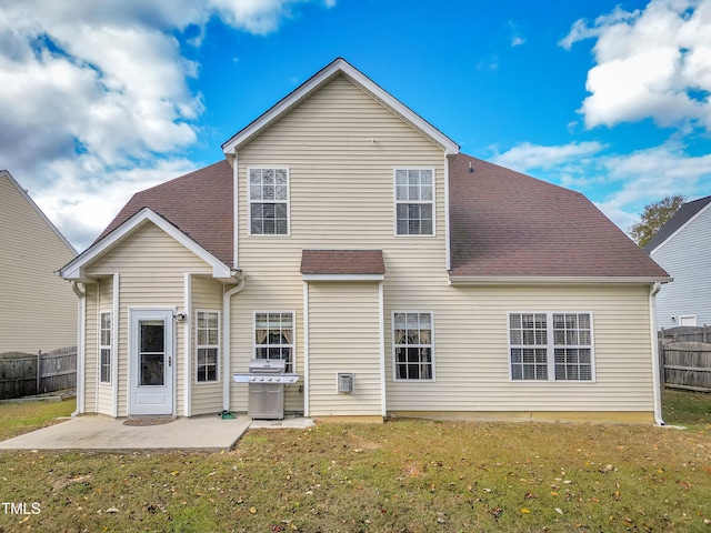 rear view of property with a yard