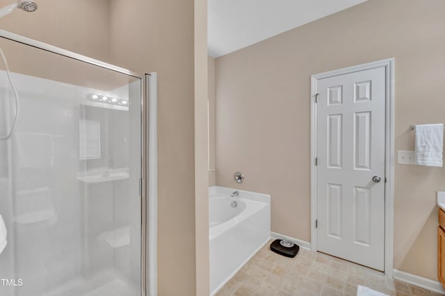 bathroom featuring vanity and independent shower and bath