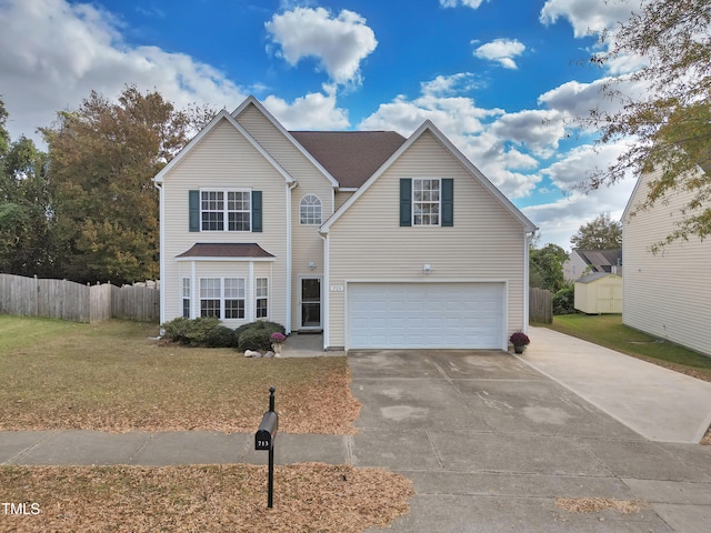 view of property with a garage and a front lawn