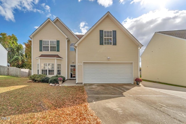 view of property featuring a garage and a front yard