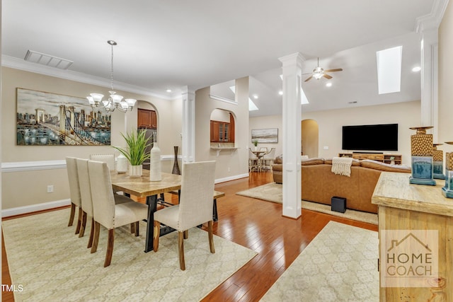 dining area with light hardwood / wood-style flooring, ornamental molding, and ceiling fan with notable chandelier