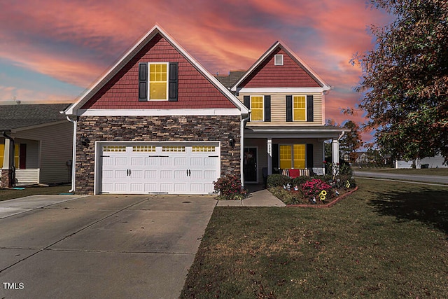 craftsman inspired home featuring a porch, a lawn, and a garage