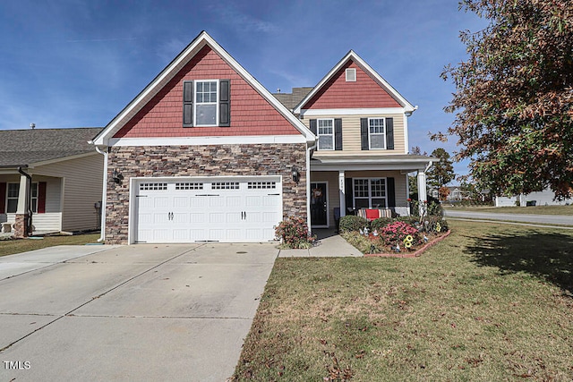 craftsman-style house featuring a garage, covered porch, and a front lawn