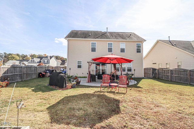 rear view of property with a patio and a lawn